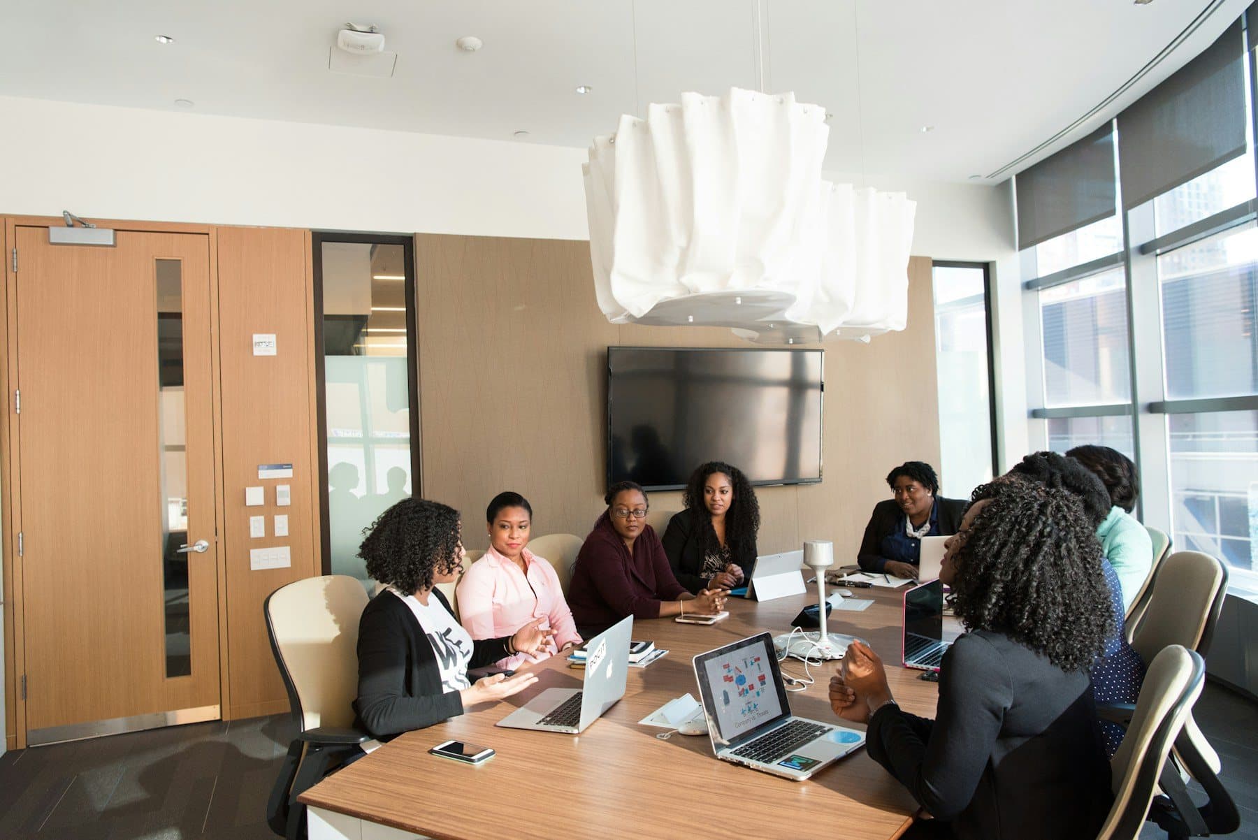 Staff working at folding tables in a bright shared room
