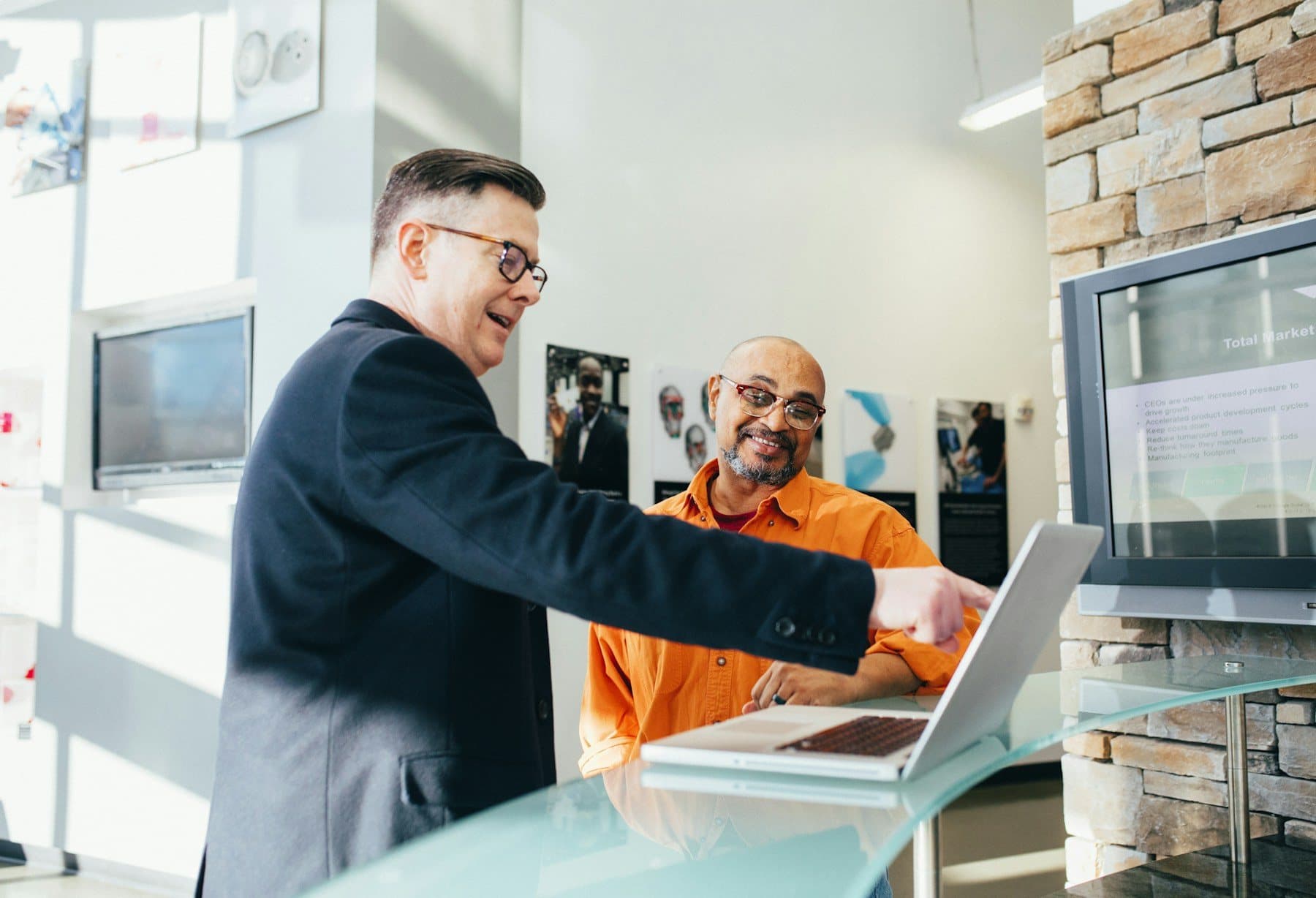 Two colleagues going through something together at a laptop